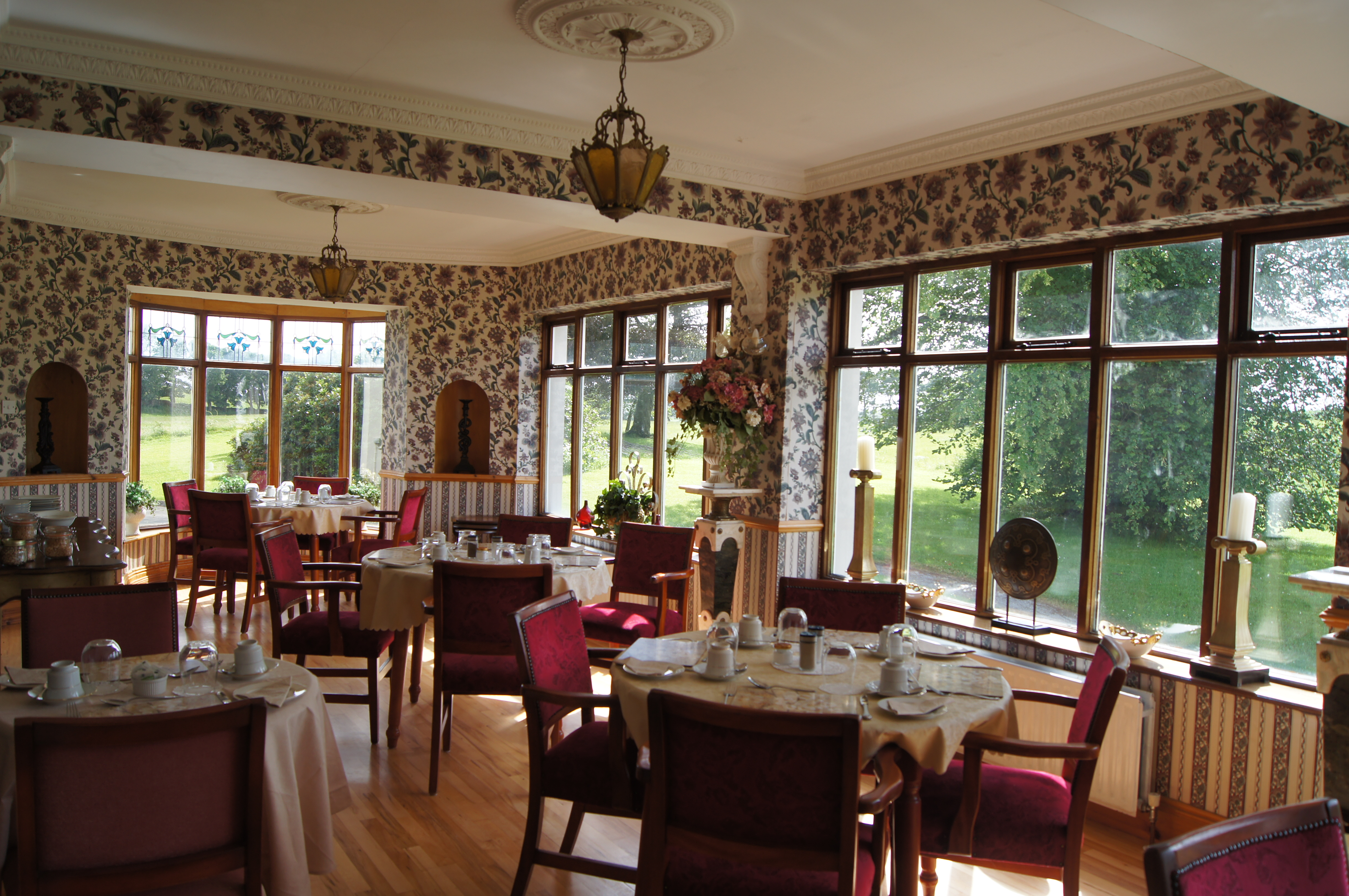The conservatory dining area at Cavangarden House, set for breakfast