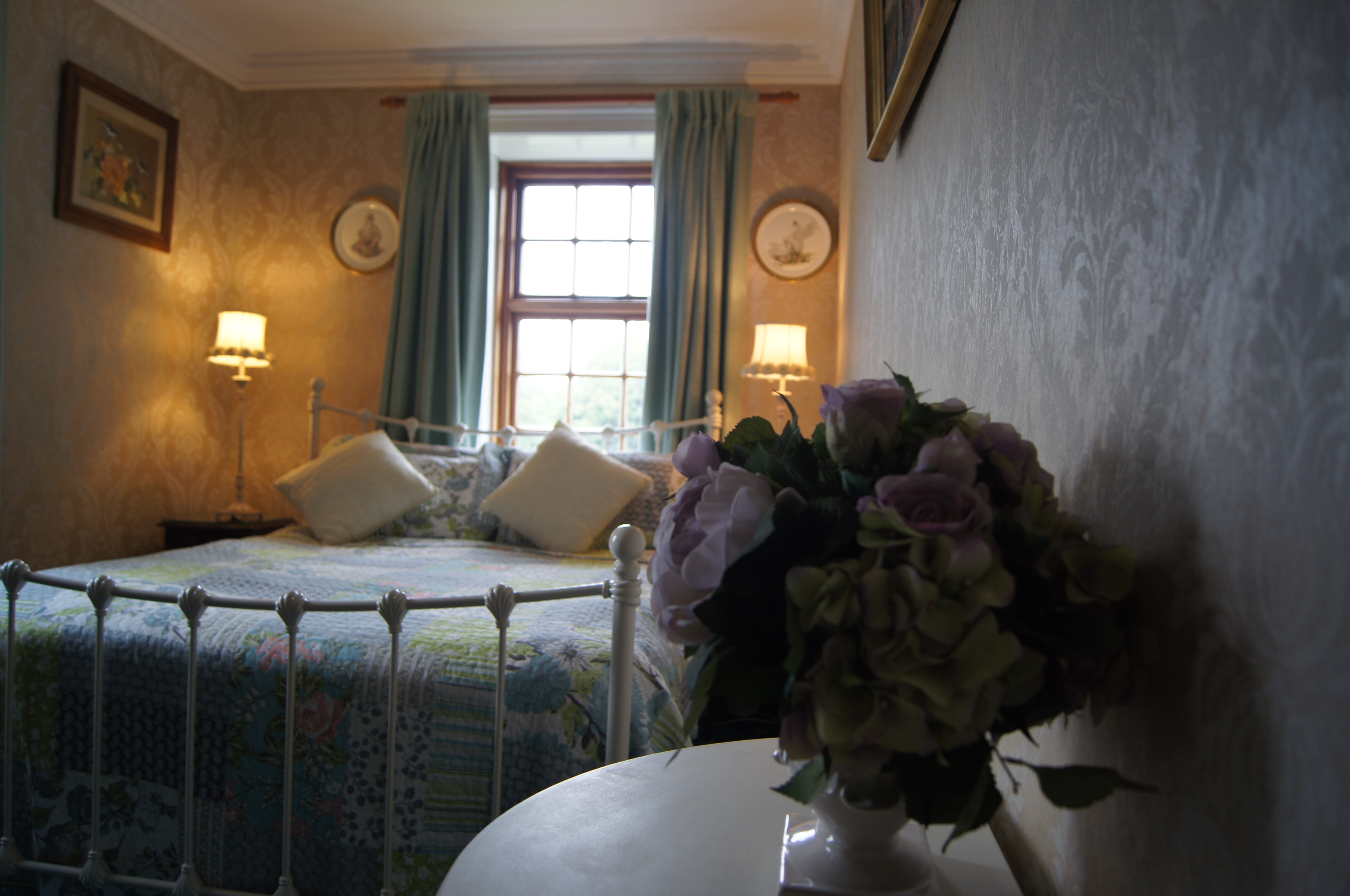 Room interior — antique iron bed with period wallpaper