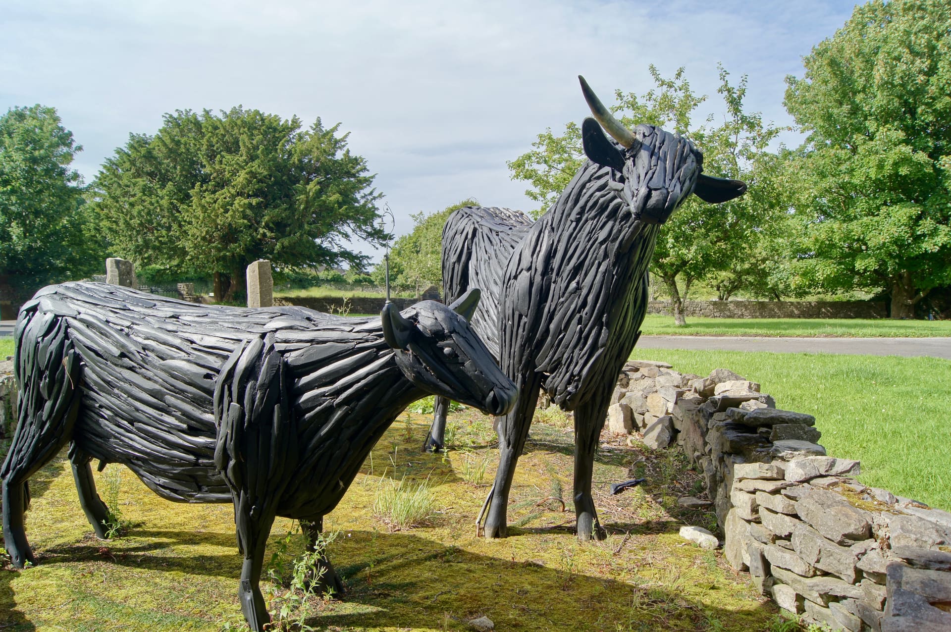 Sculpted cows beside a stone wall on the road into Ballyshannon