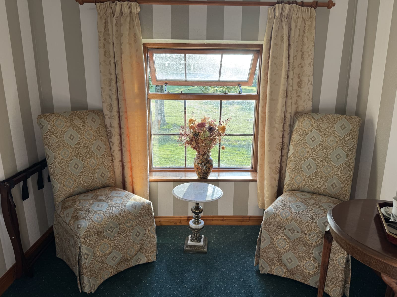 Double Ensuite window seating with two upholstered chairs and a small table