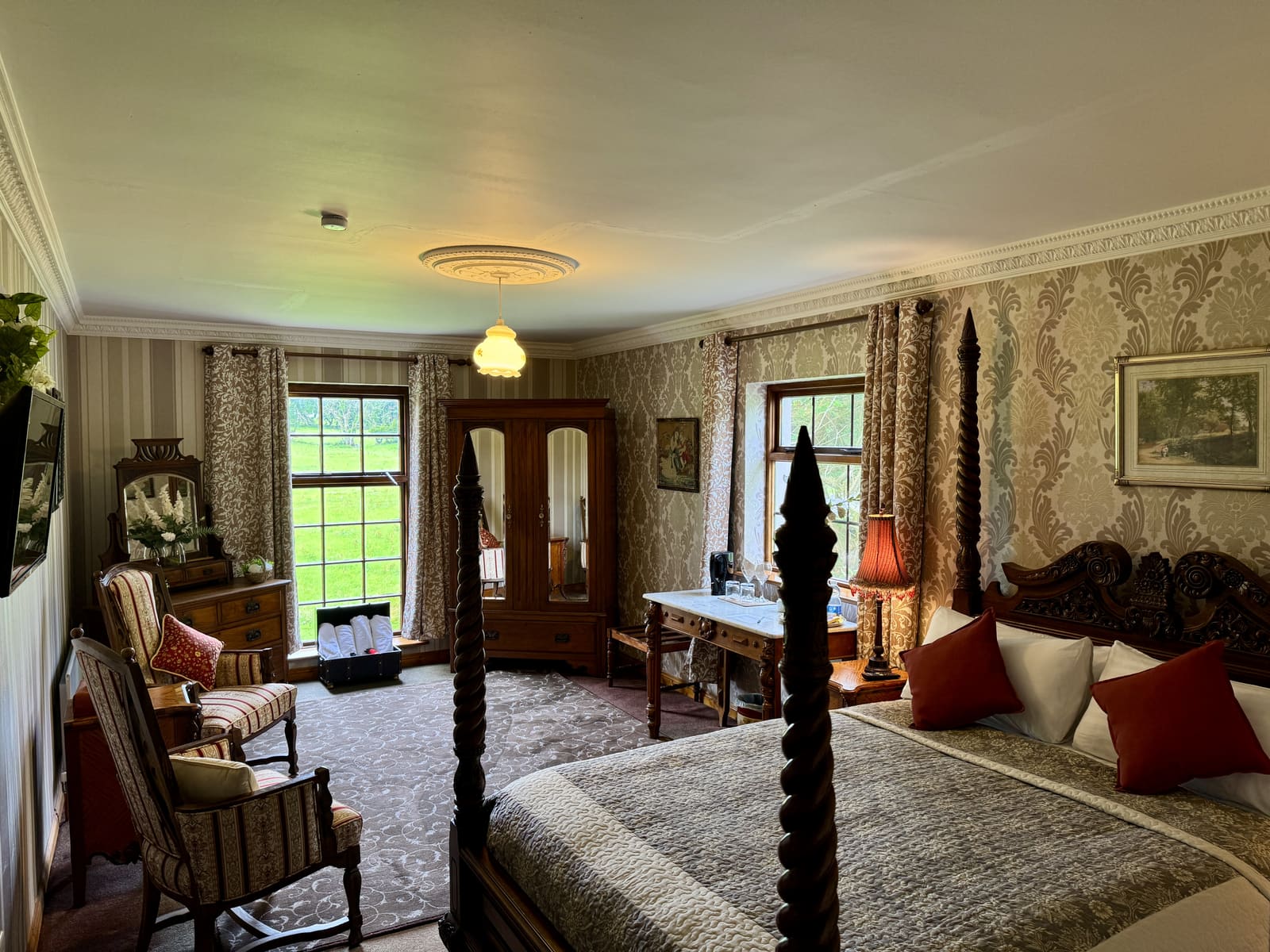 King Ensuite with a four-poster bed, antique furnishings, and views over the grounds