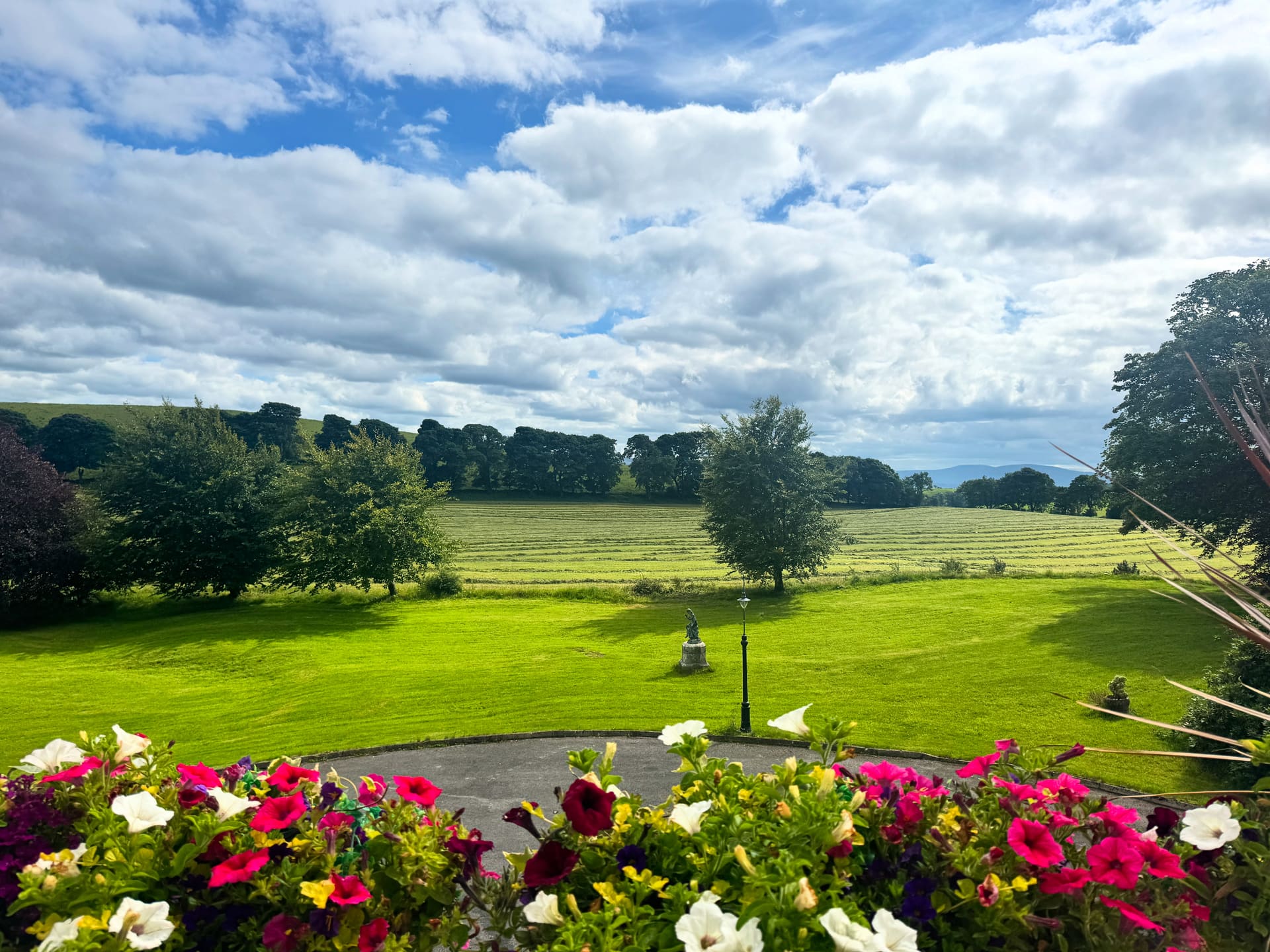 View from the front steps over the lawn toward distant hills